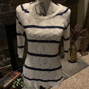 Ivory sweater with navy stripes.